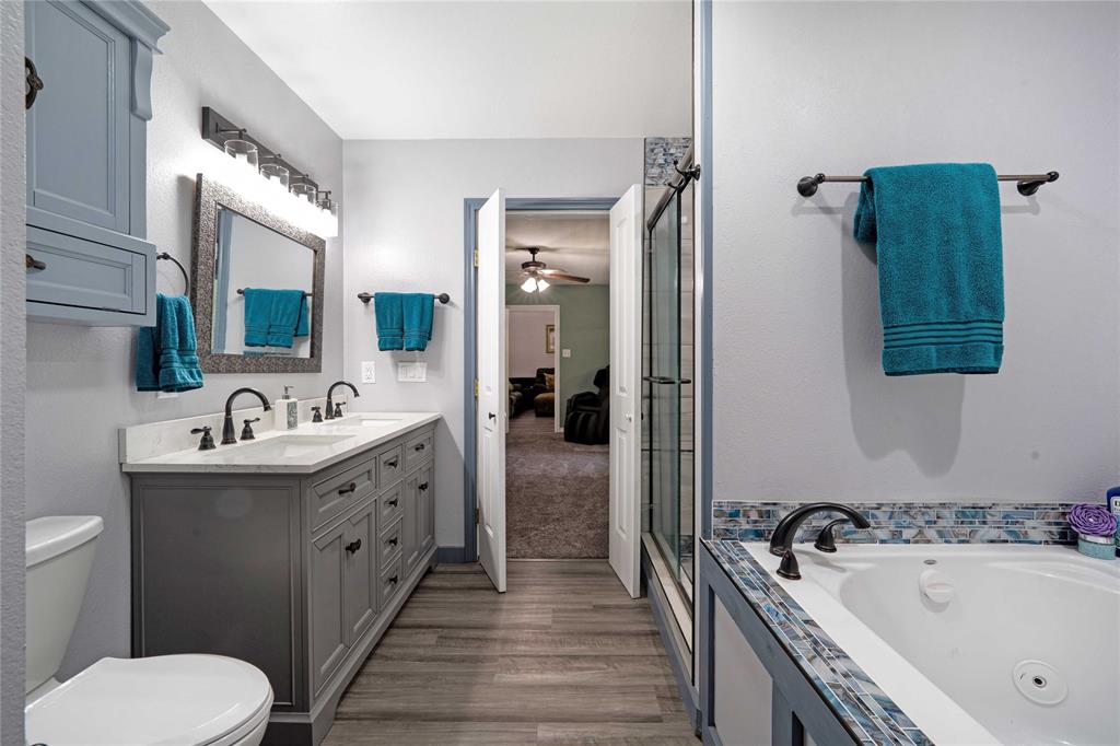 1511 North Walnut Grove Road Midlothian, TX 76065 - Photo 18 of 39 a bathroom with a tub sink and mirror