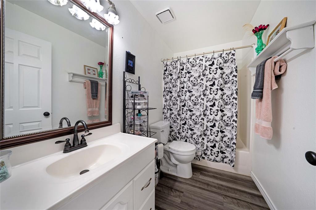 1511 North Walnut Grove Road Midlothian, TX 76065 - Photo 21 of 39 a bathroom with a sink toilet and shower