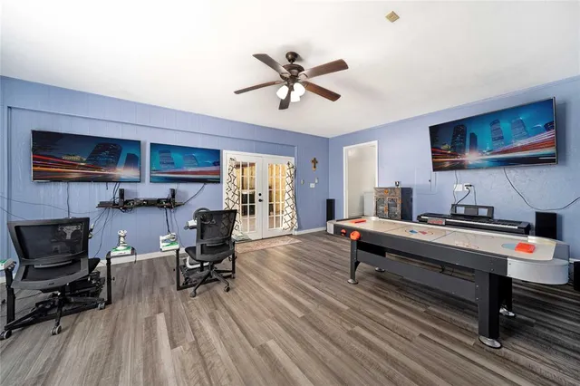 a living room with furniture and a wooden floor