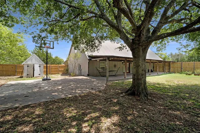 a view of a house with a tree in the forest