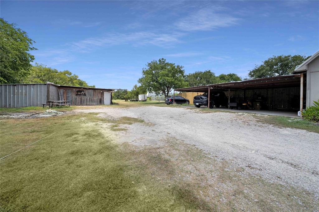 1511 North Walnut Grove Road Midlothian, TX 76065 - Photo 34 of 39 a view of a house with a yard and covered with wooden fence