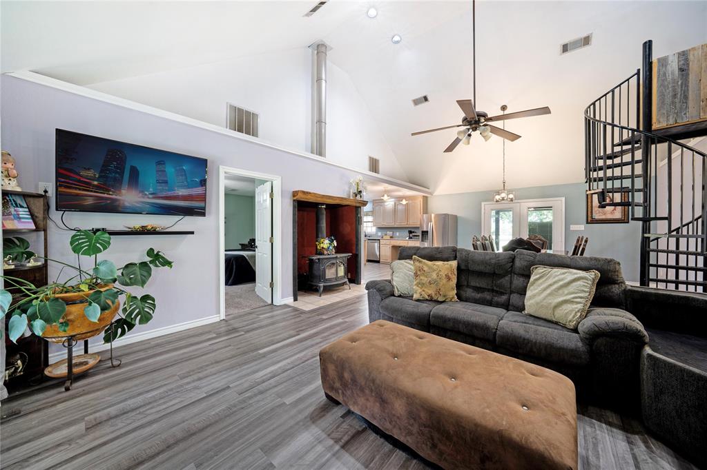 1511 North Walnut Grove Road Midlothian, TX 76065 - Photo 6 of 39 a living room with furniture a wooden floor and a chandelier