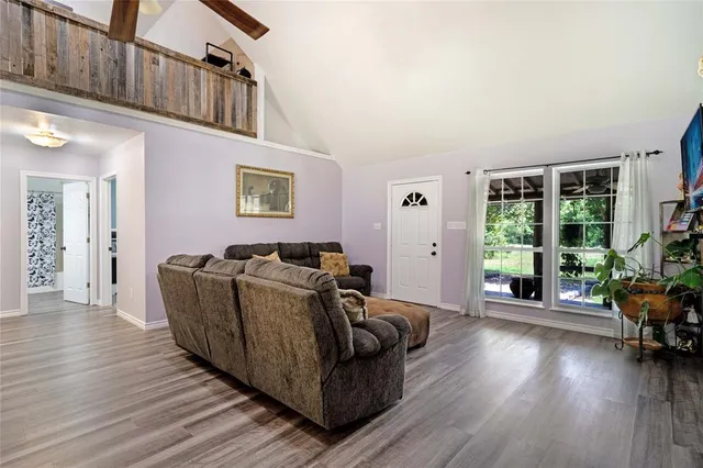 a living room with furniture and wooden floor