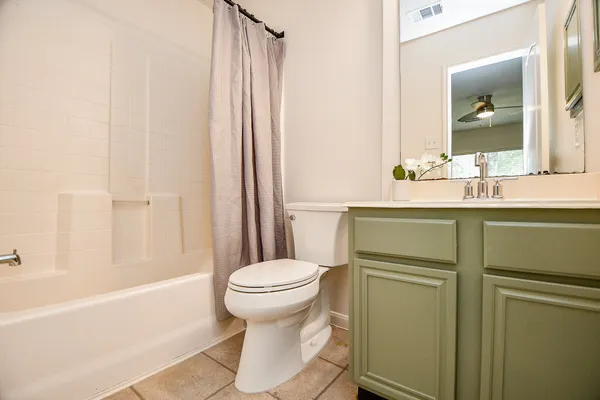 a view of a house with backyard and a tree