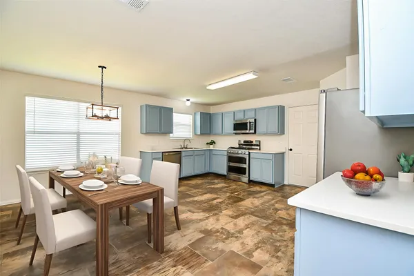 a kitchen with a sink refrigerator and cabinets