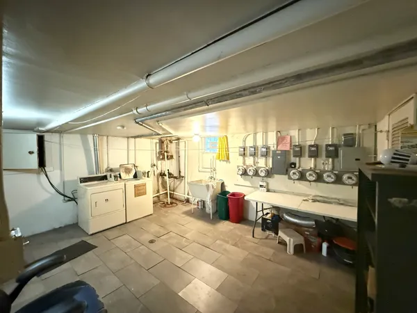 a large white kitchen with a large window and furniture