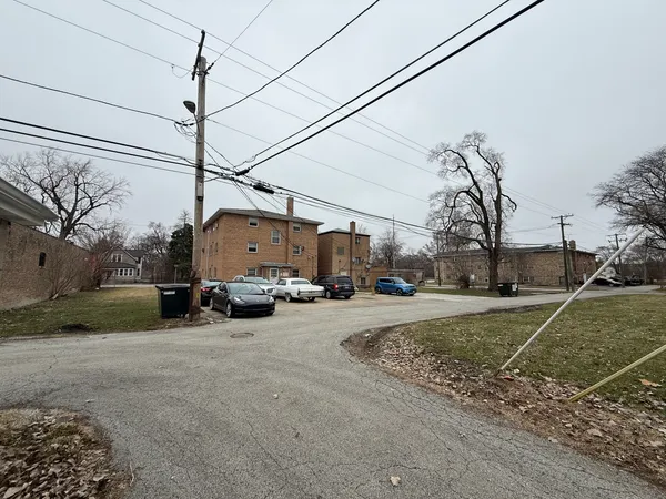 a view of a street with a car parked on the road