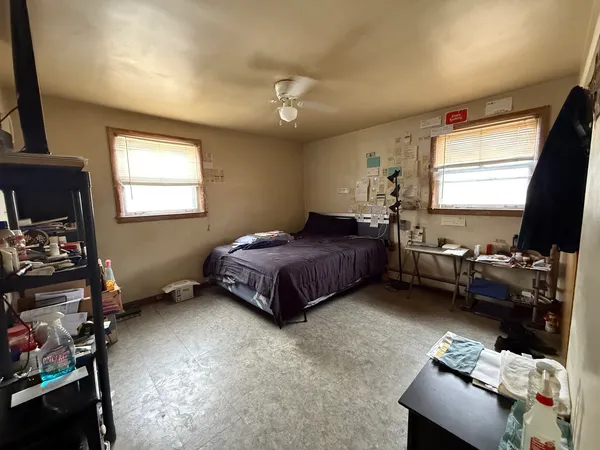a bedroom with bed window and flat screen tv