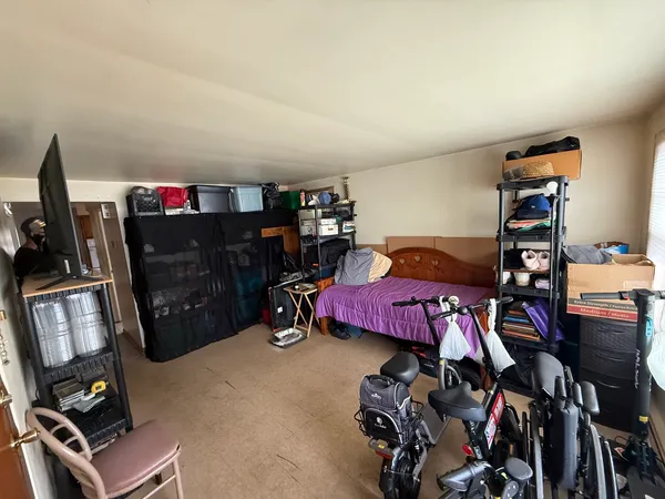 a bedroom with furniture and a gym equipment