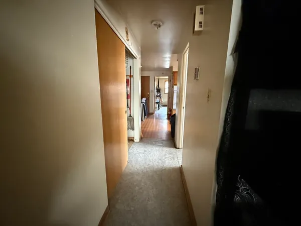 a view of hallway with furniture and a living room
