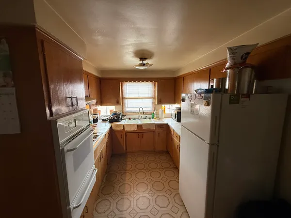 a kitchen with refrigerator and cabinets