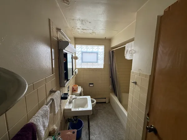 a bathroom with a sink mirror and toilet