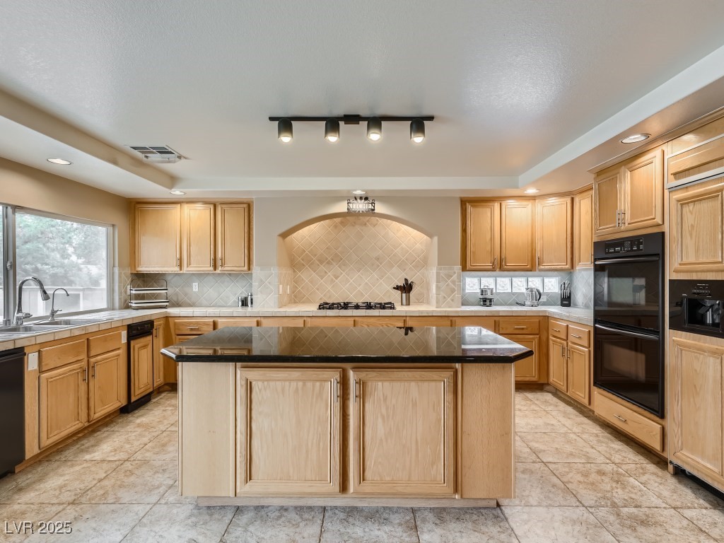 1221 Fragrant Spruce Avenue Las Vegas, NV 89123 - Photo 13 of 59 Kitchen with a center island, decorative backsplash, black appliances, recessed lighting, and light tile patterned floors