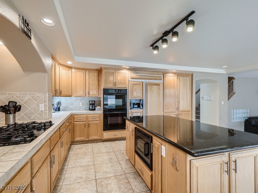 1221 Fragrant Spruce Avenue Las Vegas, NV 89123 - Photo 15 of 59 Kitchen with decorative backsplash, black appliances, recessed lighting, a kitchen island, and light tile patterned floors