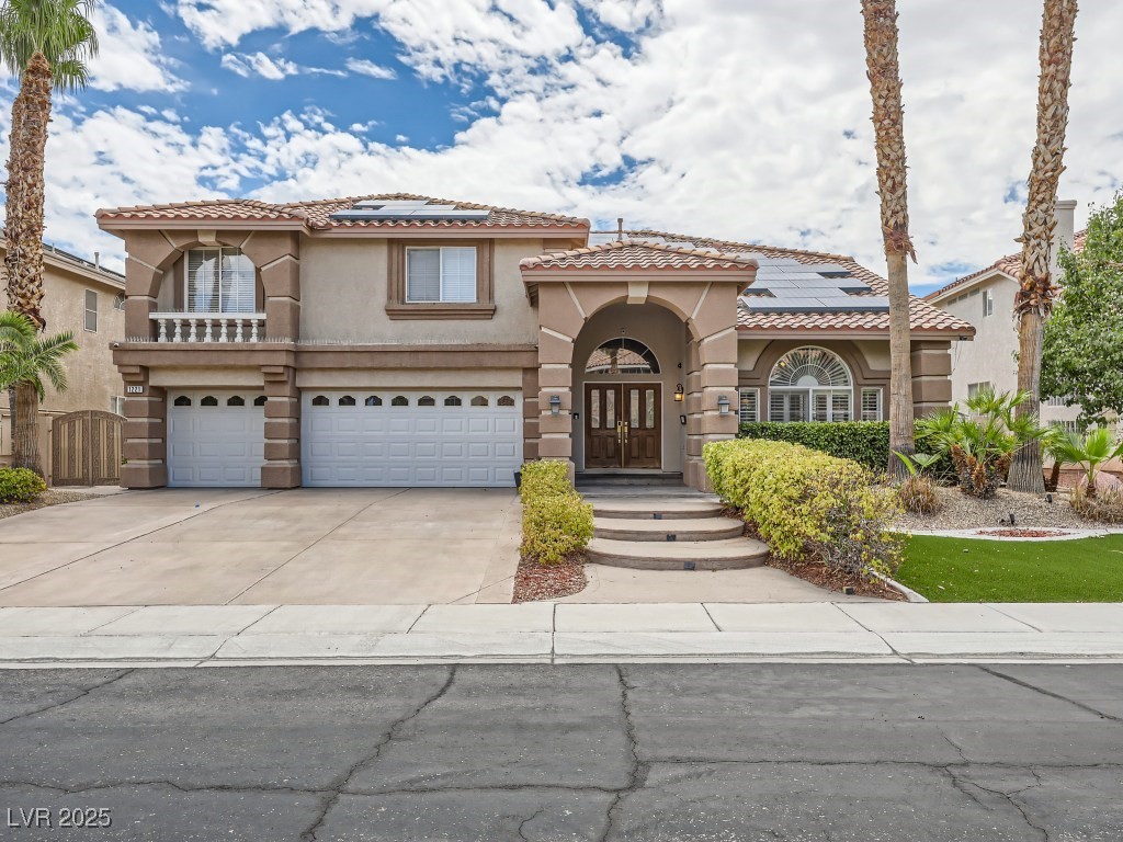 1221 Fragrant Spruce Avenue Las Vegas, NV 89123 - Photo 2 of 59 Mediterranean / spanish-style home featuring stucco siding, driveway, solar panels, and a tile roof