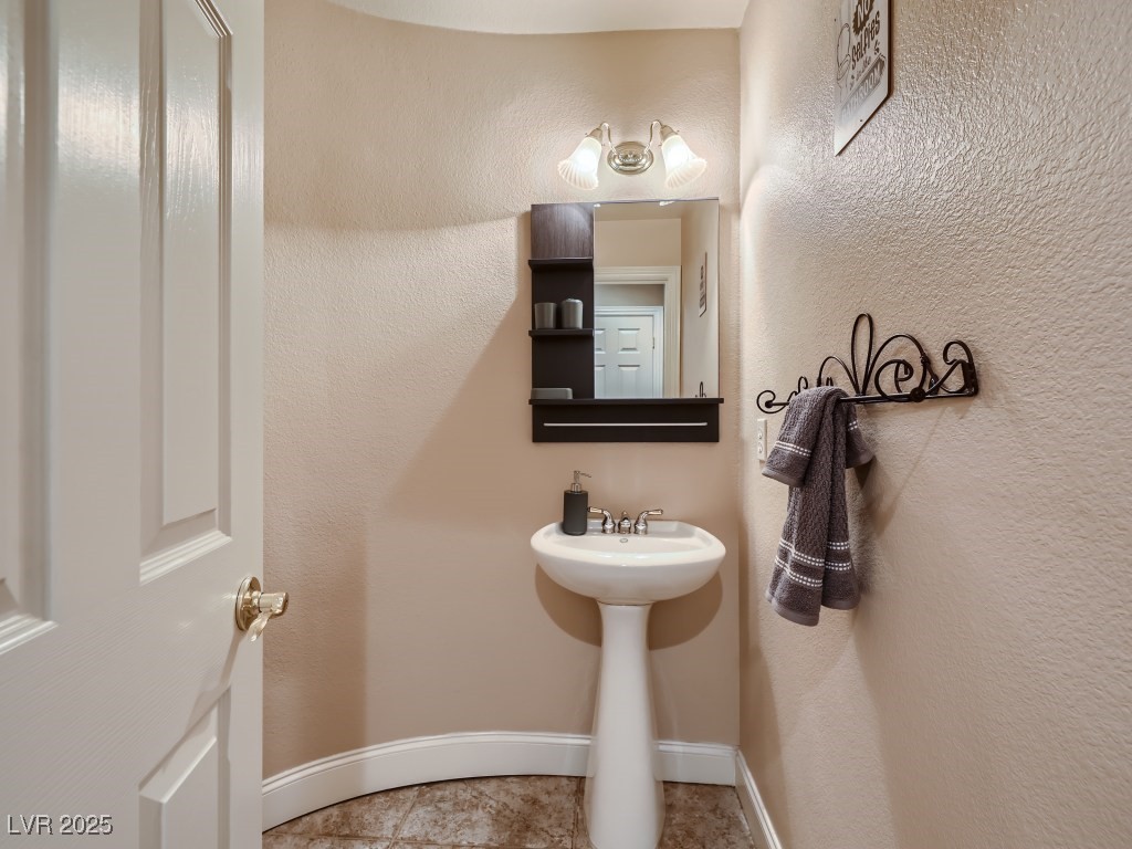 1221 Fragrant Spruce Avenue Las Vegas, NV 89123 - Photo 22 of 59 Bathroom featuring a sink, textured wall and baseboards