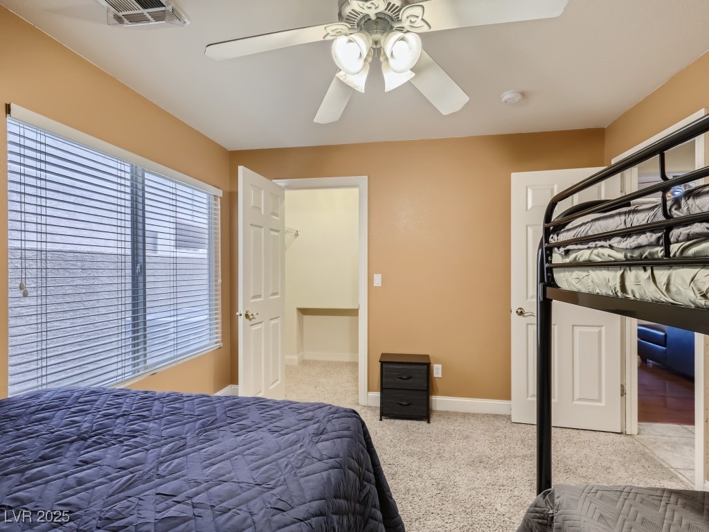 1221 Fragrant Spruce Avenue Las Vegas, NV 89123 - Photo 24 of 59 Bedroom located downstairs featuring light colored carpet, walk-in closet, and a ceiling fan with light