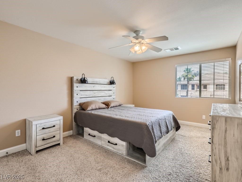 1221 Fragrant Spruce Avenue Las Vegas, NV 89123 - Photo 33 of 59 Bedroom with light colored carpet and a ceiling fan with light