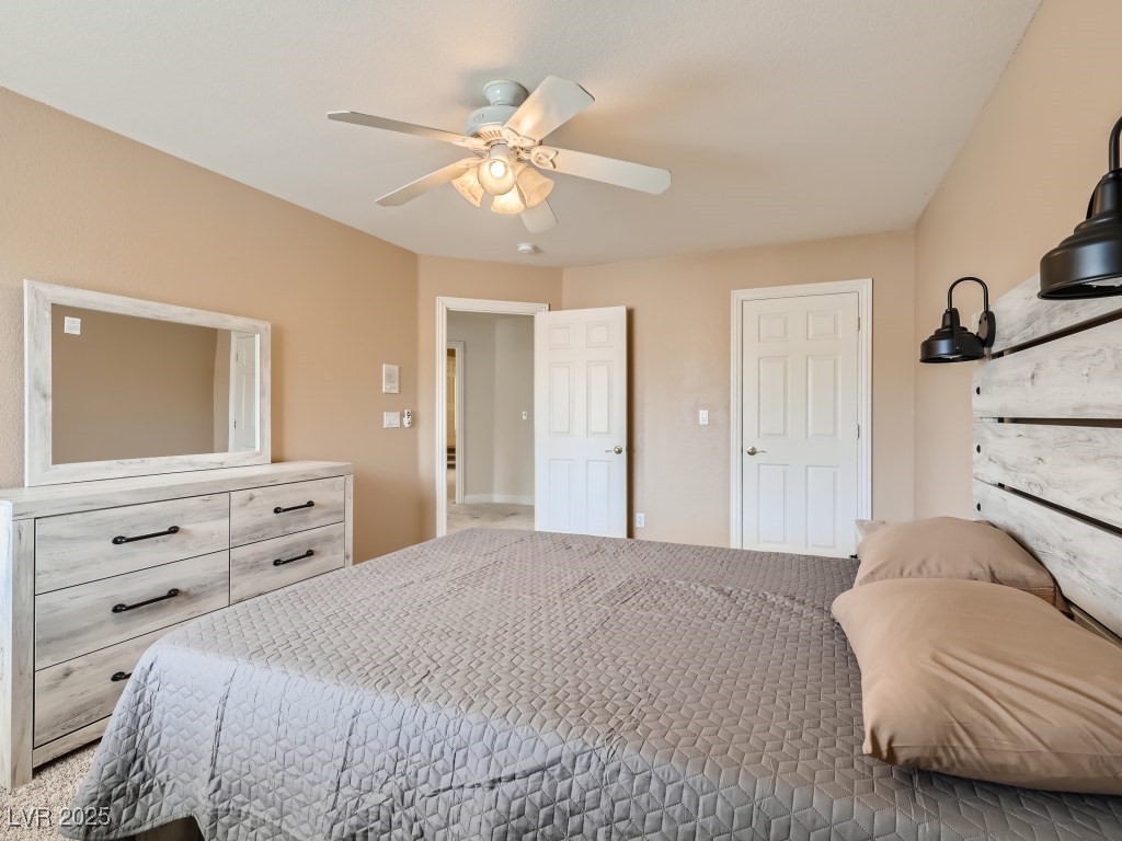 1221 Fragrant Spruce Avenue Las Vegas, NV 89123 - Photo 34 of 59 Carpeted bedroom featuring a closet and ceiling fan with light