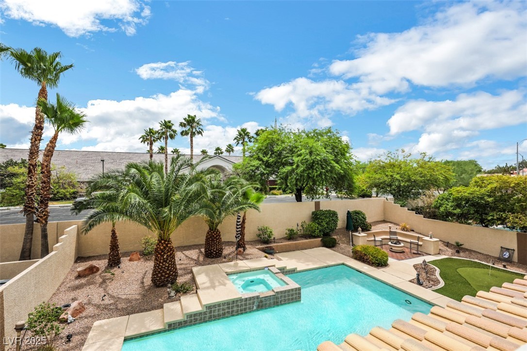 1221 Fragrant Spruce Avenue Las Vegas, NV 89123 - Photo 40 of 59 View of pool from balcony featuring a patio, a fenced backyard, and a fire pit