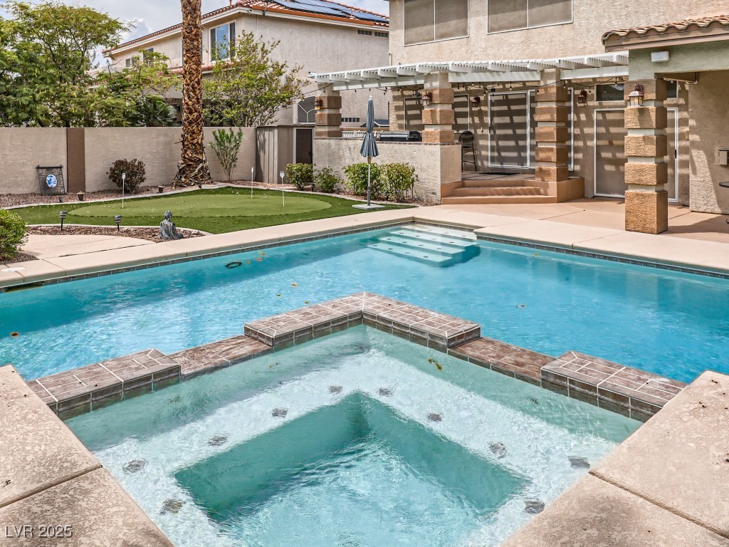 1221 Fragrant Spruce Avenue Las Vegas, NV 89123 - Photo 51 of 59 View of pool featuring a patio area, a pool with connected hot tub, a pergola, and a fenced backyard