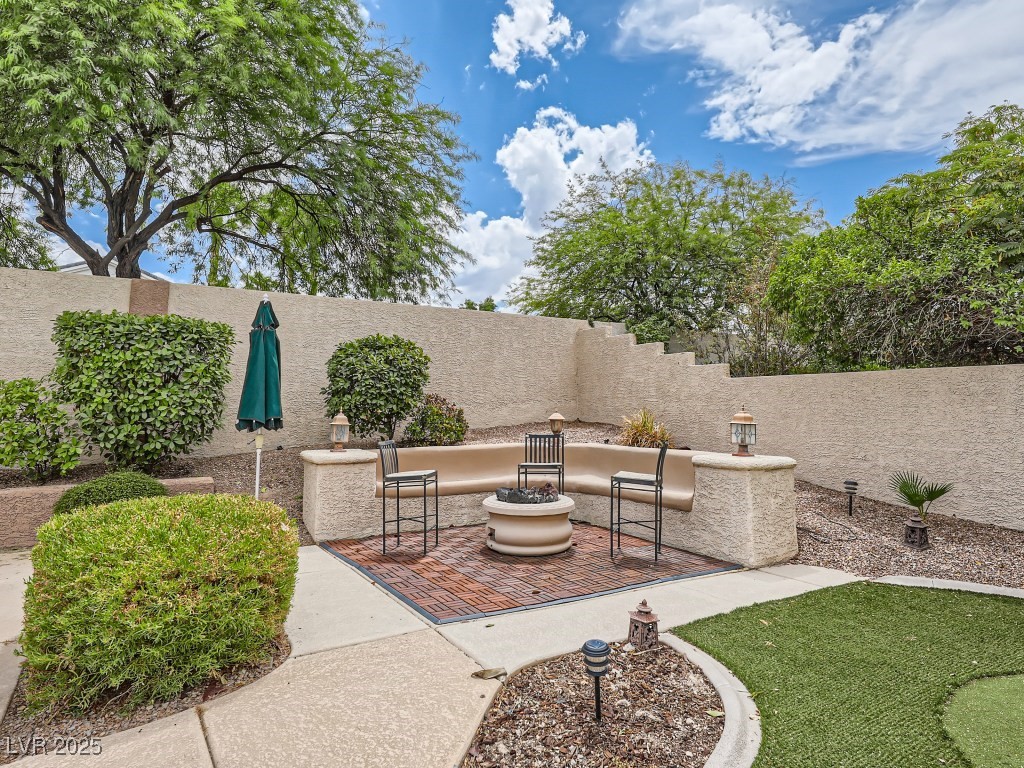 1221 Fragrant Spruce Avenue Las Vegas, NV 89123 - Photo 54 of 59 Fenced backyard featuring a patio and a fire pit sitting area