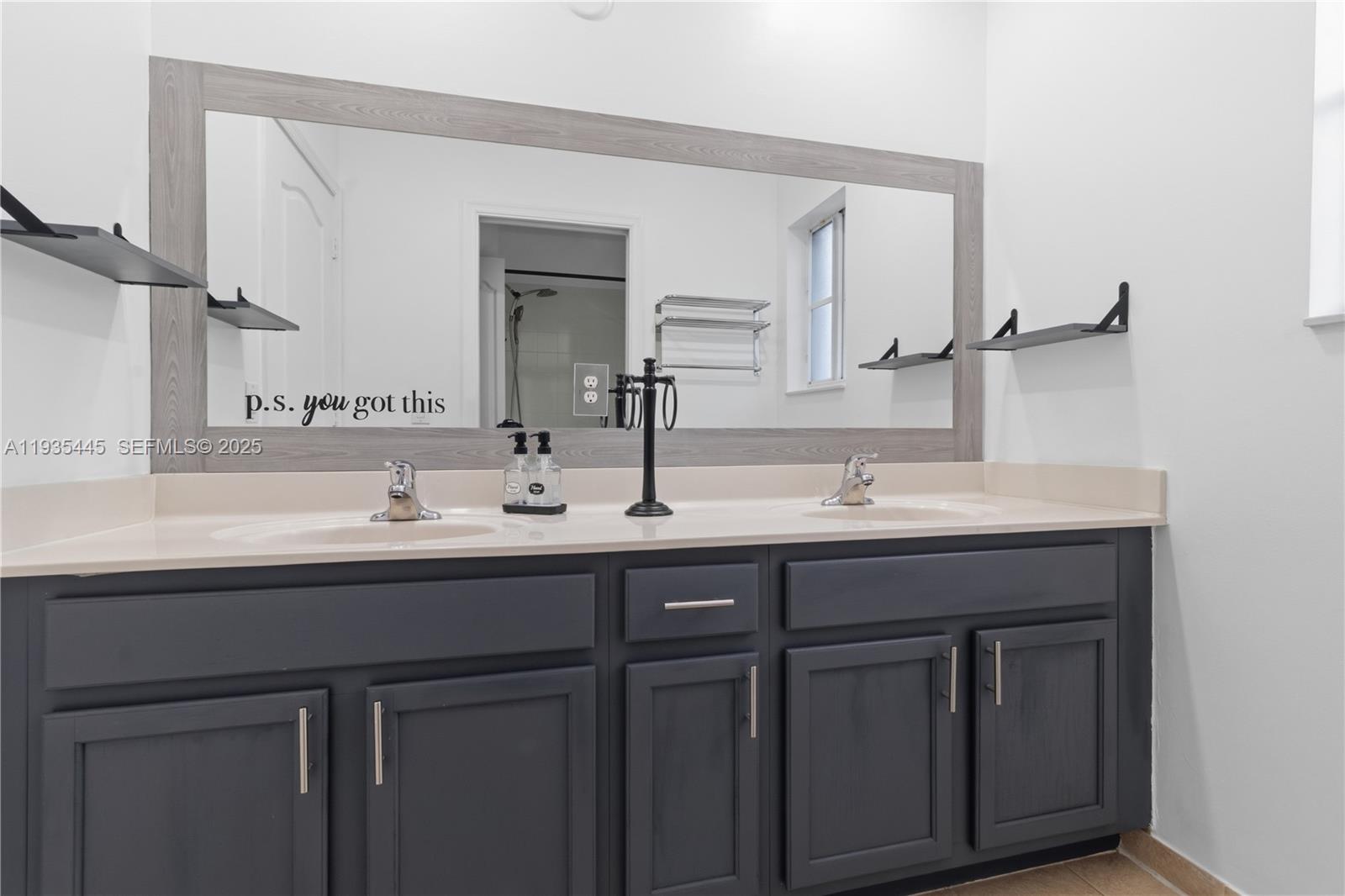 27049 Southwest 142nd Avenue Homestead, FL 33032 - Photo 11 of 36 a bathroom with double sink and a mirror