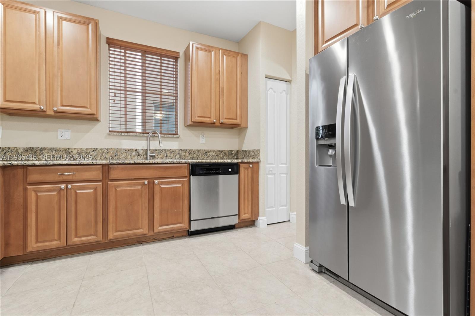 27049 Southwest 142nd Avenue Homestead, FL 33032 - Photo 21 of 36 a kitchen with stainless steel appliances granite countertop a refrigerator and a sink