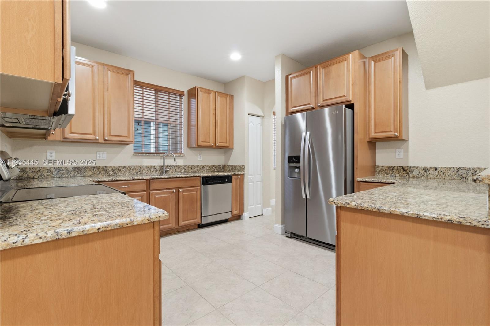 27049 Southwest 142nd Avenue Homestead, FL 33032 - Photo 23 of 36 a kitchen with stainless steel appliances granite countertop a refrigerator a stove and a sink