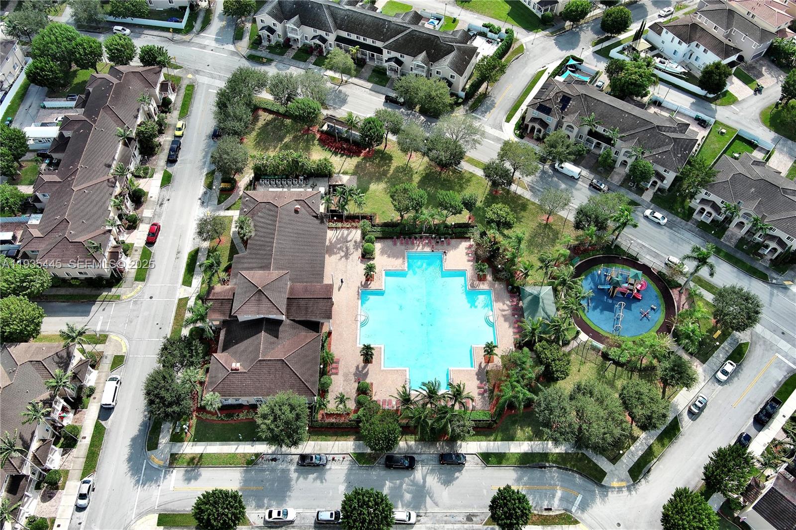 27049 Southwest 142nd Avenue Homestead, FL 33032 - Photo 32 of 36 an aerial view of residential houses with outdoor space and swimming pool