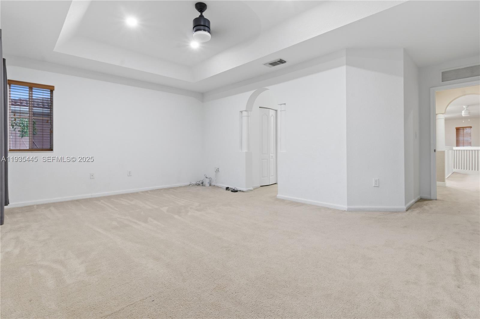 27049 Southwest 142nd Avenue Homestead, FL 33032 - Photo 9 of 36 an empty room with a ceiling fan and window