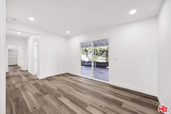 a view of an empty room and wooden floor