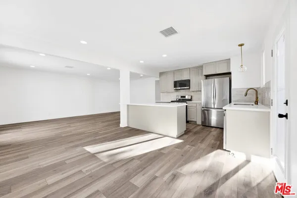 a view of kitchen with sink microwave and refrigerator