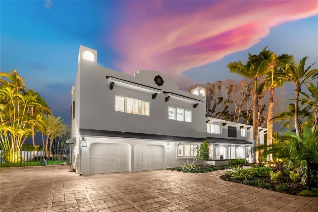 a front view of a house with a yard and tree s