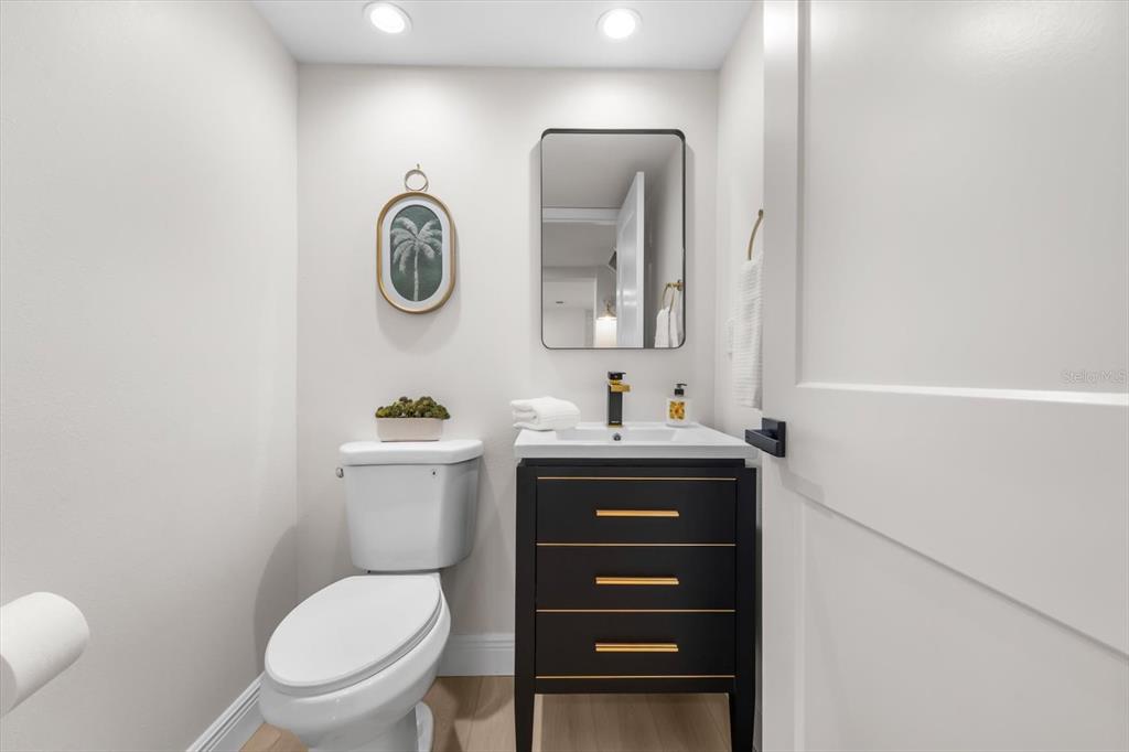 16895 1st Street East North Redington Beach, FL 33708 - Photo 13 of 97 a bathroom with a toilet a sink and mirror