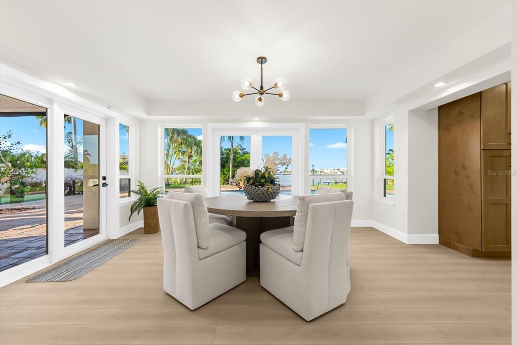 16895 1st Street East North Redington Beach, FL 33708 - Photo 19 of 97 a dining room with furniture window wooden floor