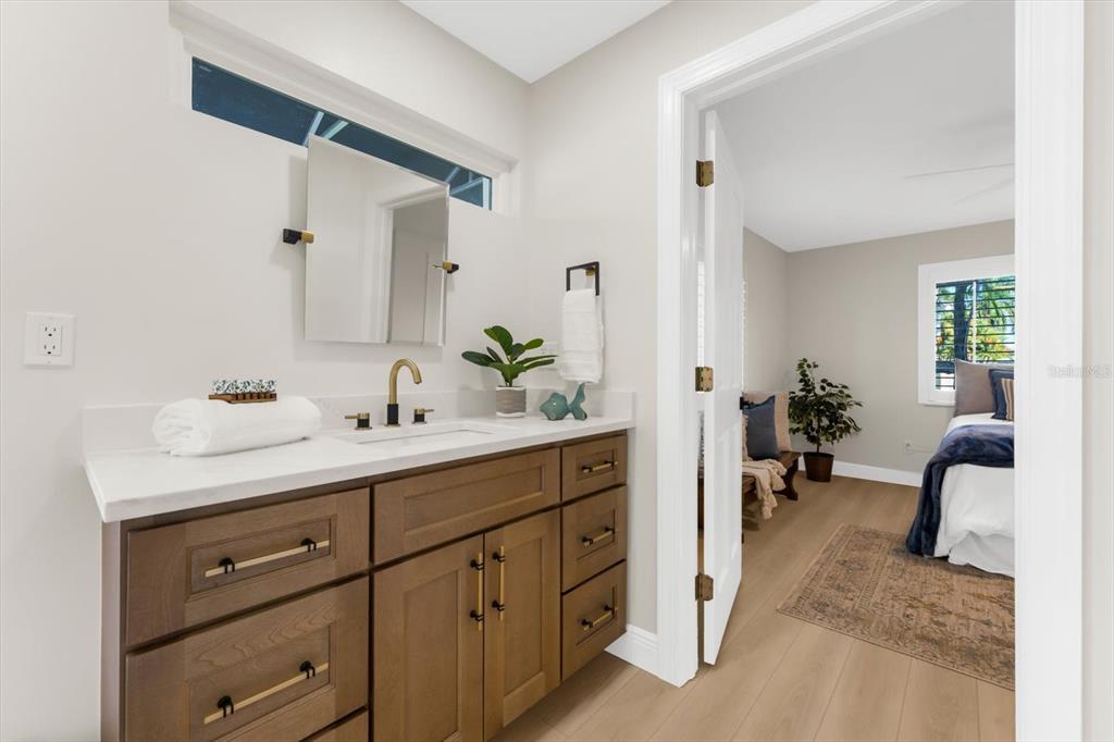 16895 1st Street East North Redington Beach, FL 33708 - Photo 25 of 96 a spacious bathroom with a double vanity sink and a mirror