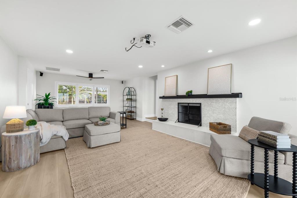 16895 1st Street East North Redington Beach, FL 33708 - Photo 34 of 96 a living room with furniture and a fireplace