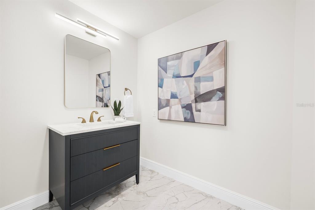 16895 1st Street East North Redington Beach, FL 33708 - Photo 37 of 97 a bathroom with a sink and a mirror