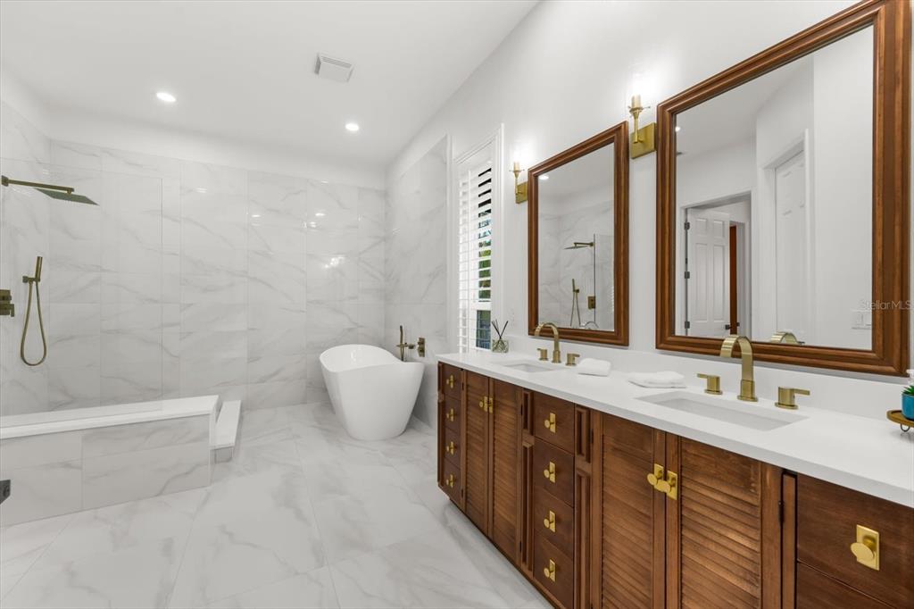 16895 1st Street East North Redington Beach, FL 33708 - Photo 46 of 97 a bathroom with a double vanity sink mirror and double