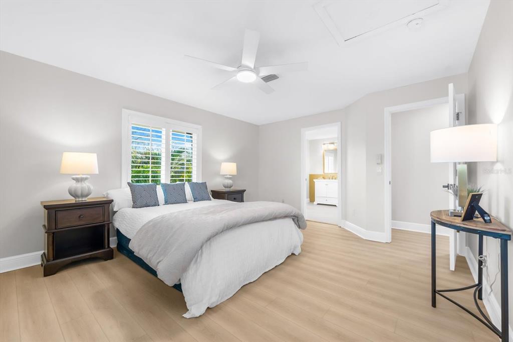 16895 1st Street East North Redington Beach, FL 33708 - Photo 58 of 97 a bedroom with a bed and a lamp on table