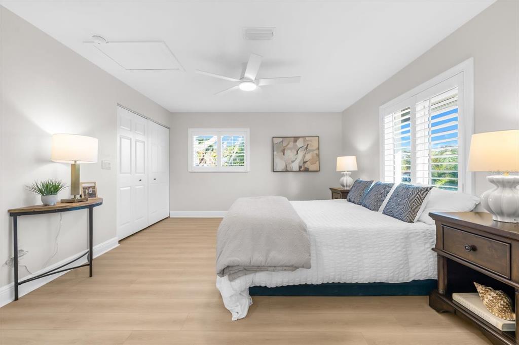 16895 1st Street East North Redington Beach, FL 33708 - Photo 58 of 96 a bedroom with a large bed and a chandelier