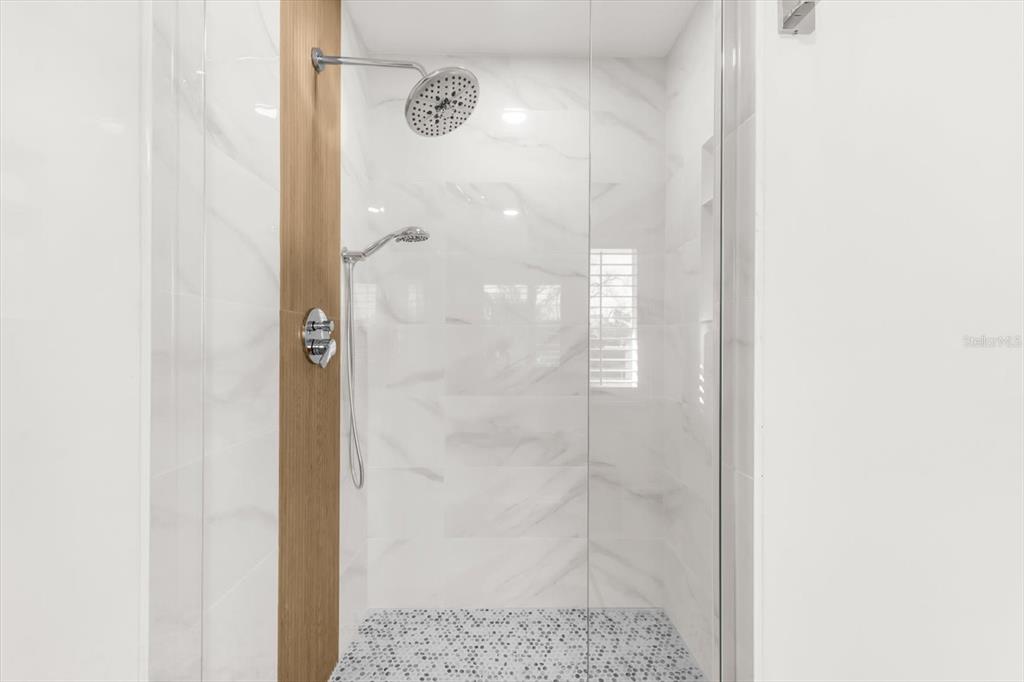 16895 1st Street East North Redington Beach, FL 33708 - Photo 60 of 97 a bathroom with a glass shower door