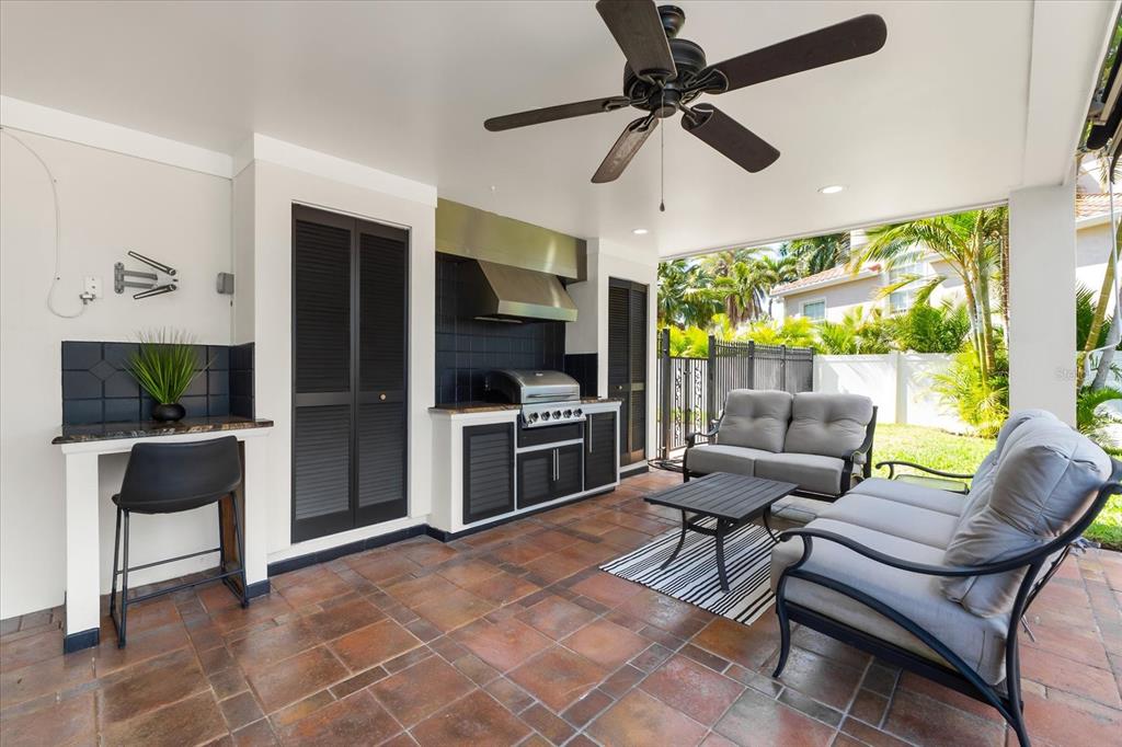 16895 1st Street East North Redington Beach, FL 33708 - Photo 62 of 97 a living room with furniture a ceiling fan and a flat screen tv