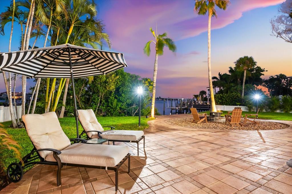 16895 1st Street East North Redington Beach, FL 33708 - Photo 91 of 97 a view of a patio with a table and chairs under an umbrella