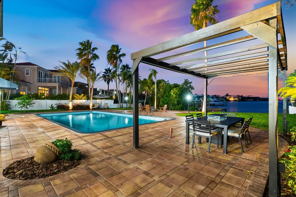 16895 1st Street East North Redington Beach, FL 33708 - Photo 95 of 97 a view of a patio with a table and chairs under an umbrella