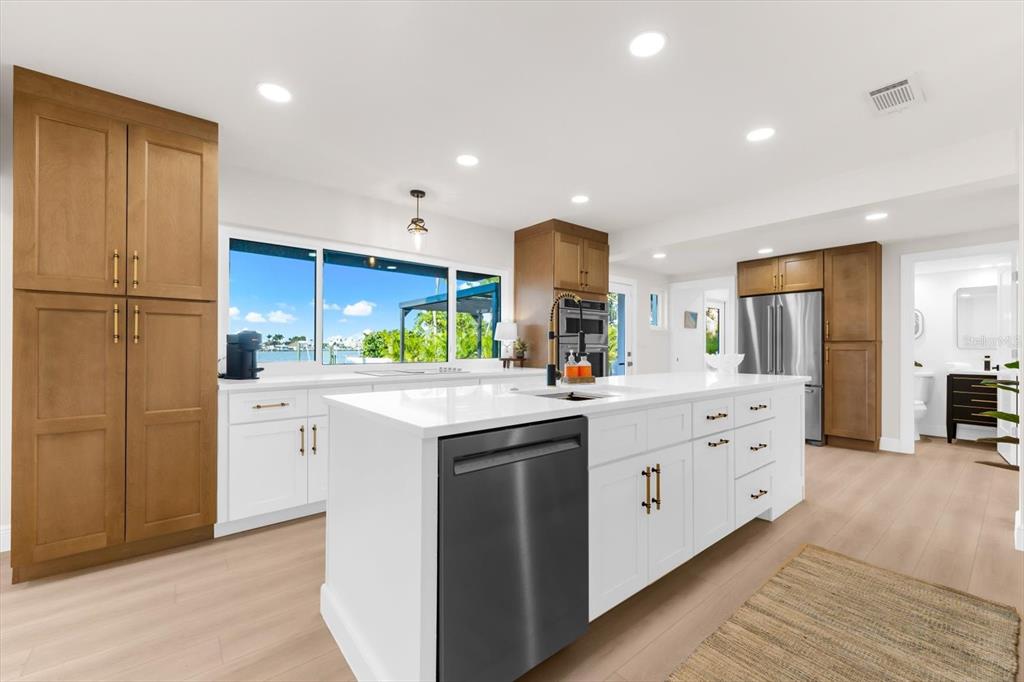 16895 1st Street East North Redington Beach, FL 33708 - Photo 10 of 97 a kitchen with kitchen island granite countertop appliances cabinets and a sink