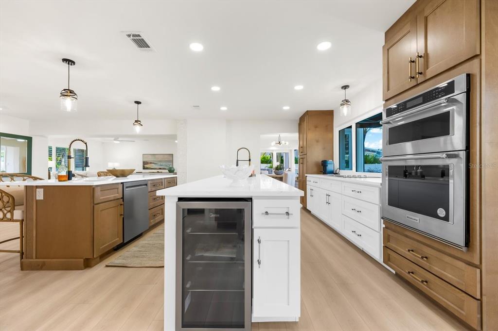 16895 1st Street East North Redington Beach, FL 33708 - Photo 10 of 96 a kitchen with stainless steel appliances kitchen island granite countertop a stove a sink and a refrigerator