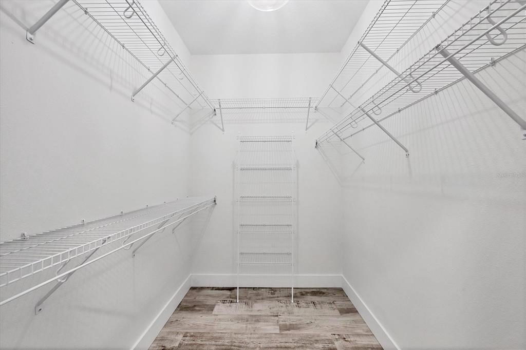 9203 Griggs Road, Unit A204 Englewood, FL 34224 - Photo 21 of 54 a view of walk in closet with empty racks