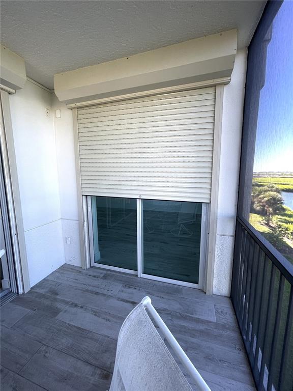 9203 Griggs Road, Unit A204 Englewood, FL 34224 - Photo 33 of 54 a view of a hallway with wooden floor and a fireplace